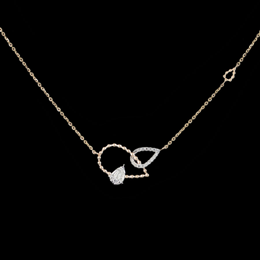 Elegant gold-toned necklace with a unique heart and teardrop duo, accented by sparkling stones for a romantic touch. Redefine delicate beauty with jnjbymadhuri signature finesse.
