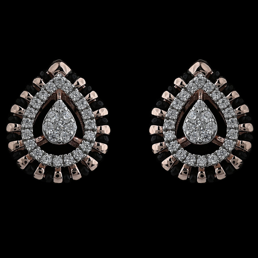 Elegant teardrop earrings encrusted with brilliant diamonds and bordered with rose gold accents for a regal look. A signature design by jnjbymadhuri.