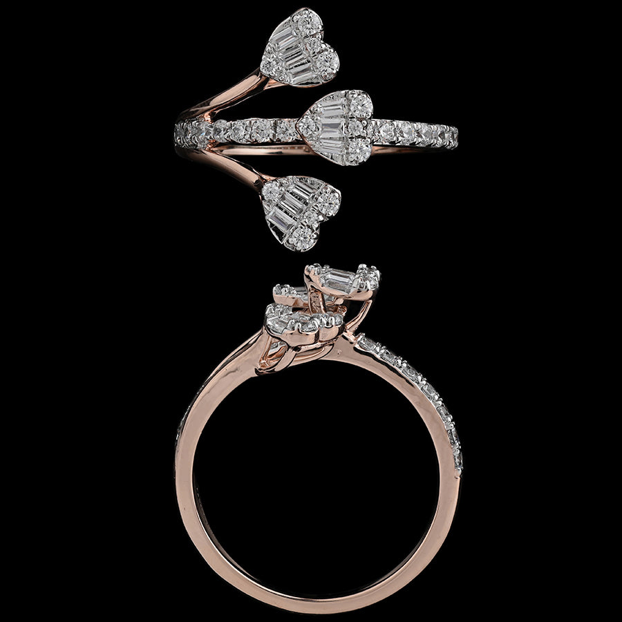 Close-up of a rose gold bypass ring adorned with three sparkling heart-shaped diamond clusters and pavé-set accents. A romantic statement piece by jnjbymadhuri.