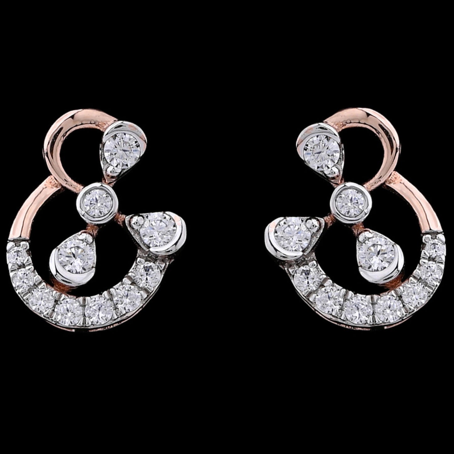 "Elegant rose gold earrings from jnjbymadhuri featuring an abstract ampersand-inspired design, adorned with sparkling round and teardrop-shaped diamonds, showcased on a black background."