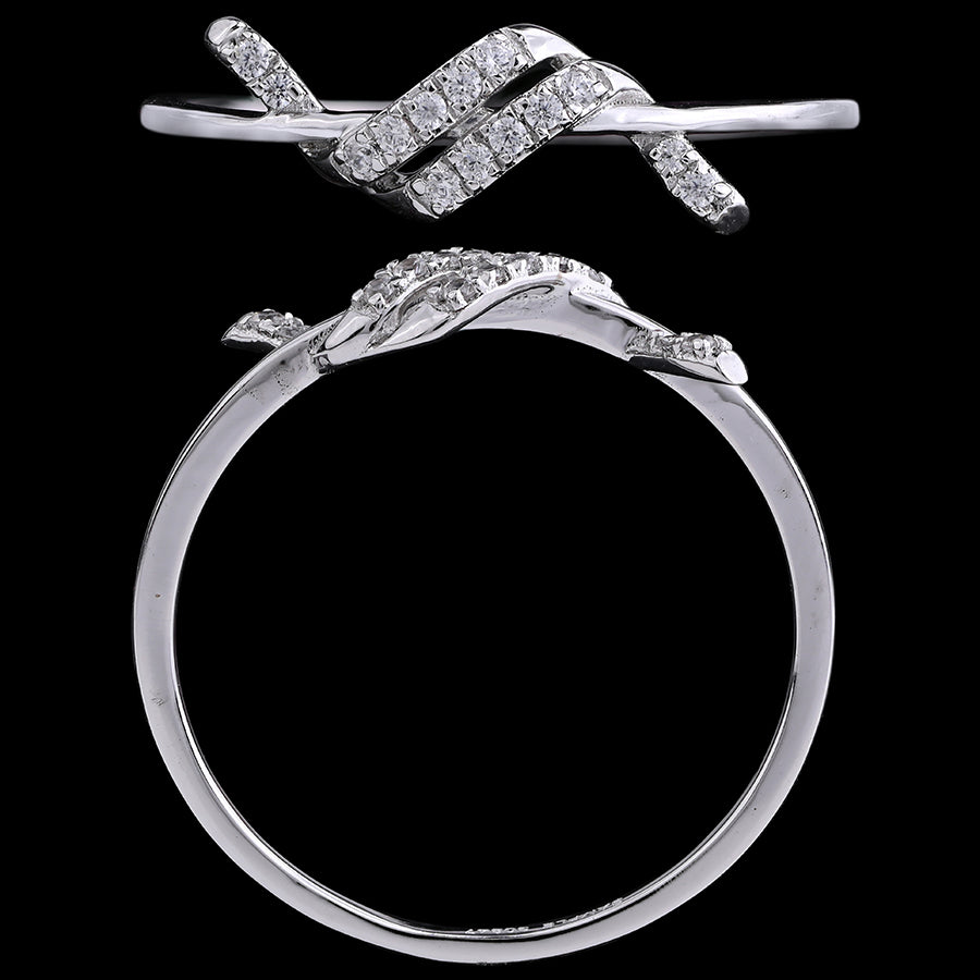 Close-up view of a white gold diamond ring featuring an intricate intertwined design, by jnjbymadhuri, displayed against a black background.