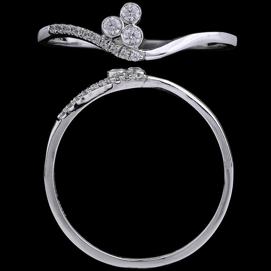A sleek silver ring featuring a delicate wavy band and three sparkling diamonds arranged in a floral motif, showcased against a black background to highlight its refined craftsmanship and elegance, from jnjbymadhuri.