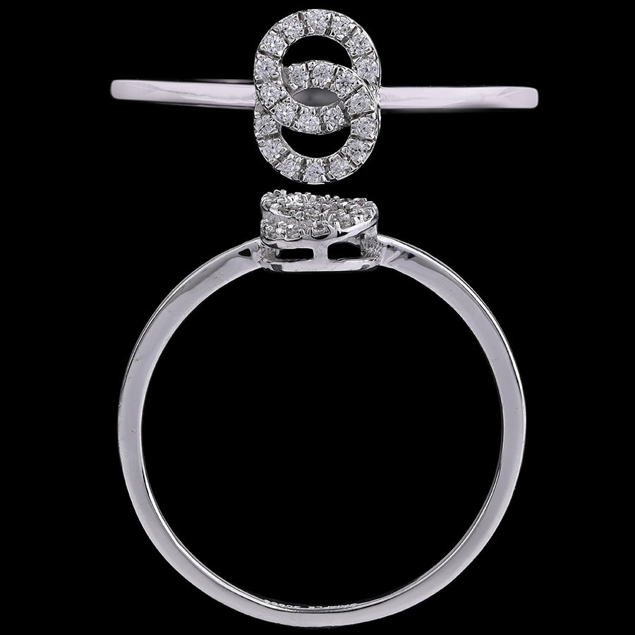 A close-up image of an elegant silver ring featuring two interlocking circular motifs encrusted with diamonds, displayed against a black background to highlight its intricate design and sparkle, from jnjbymadhuri.
