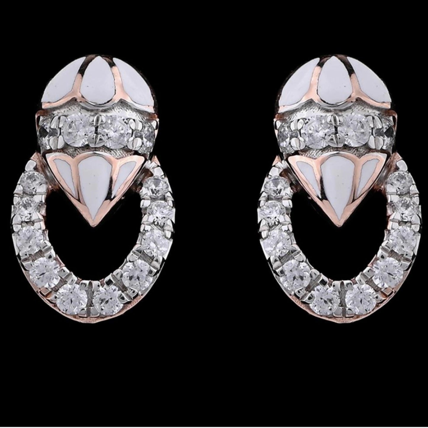 A close-up image of intricately designed earrings from jnjbymadhuri, featuring a luxurious combination of white enamel and sparkling diamonds arranged in a looped pattern, showcasing the brand's signature elegance and craftsmanship against a sleek black background.