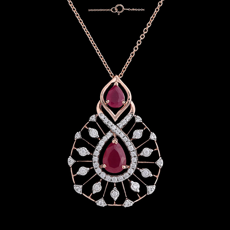 Elegant rose gold necklace with a dual ruby teardrop pendant and diamond detailing by jnjbymadhuri, displayed against a black background.