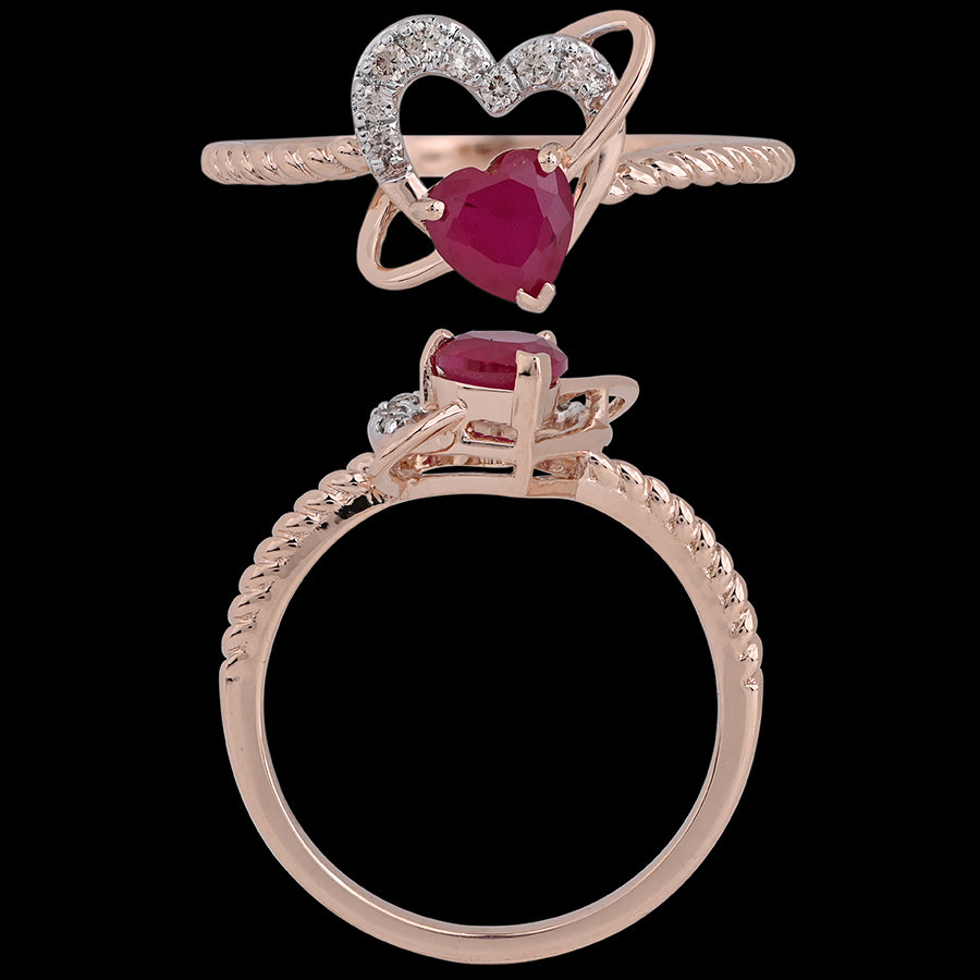 A rose gold ring featuring a heart-shaped red gemstone framed by a diamond-studded heart design. This romantic and elegant piece is a signature creation by jnjbymadhuri.