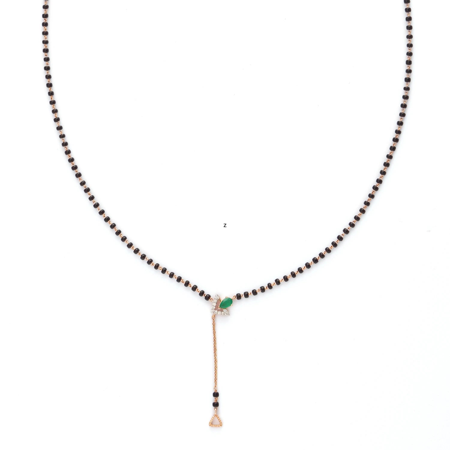 A minimalistic and elegant mangalsutra by jnjbymadhuri, showcasing a classic black bead chain with a sleek gold drop pendant. The centerpiece features a subtle green gemstone accent, adding a touch of color and sophistication to the design. Perfect for modern brides who appreciate understated traditional jewelry with a contemporary twist.