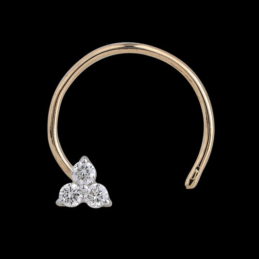 Delicate gold nose ring adorned with a trio of shimmering diamonds forming a subtle floral cluster. A refined, graceful touch by jnjbymadhuri.