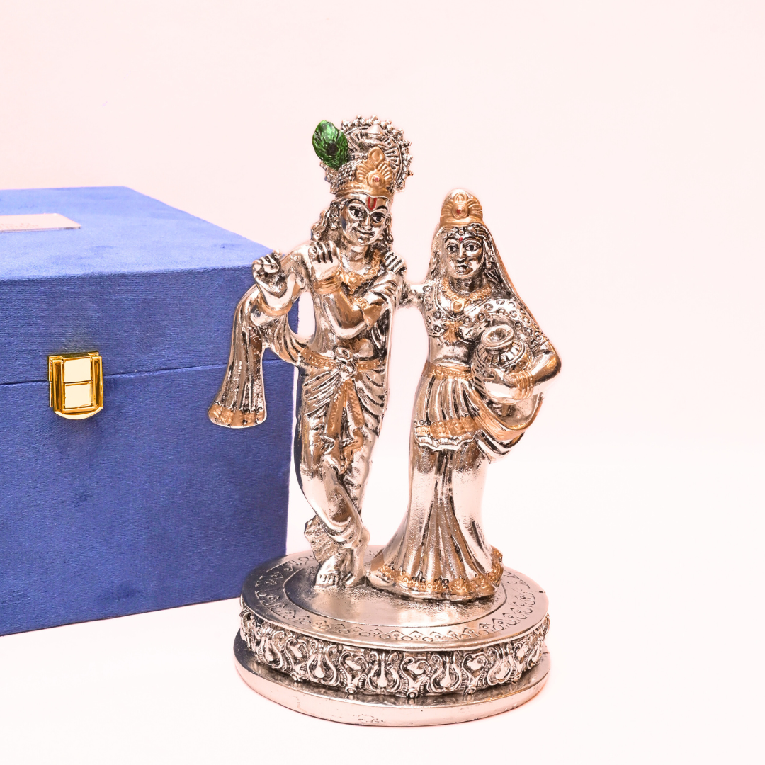 Decorative statue of a couple on a pedestal with a blue box in the background