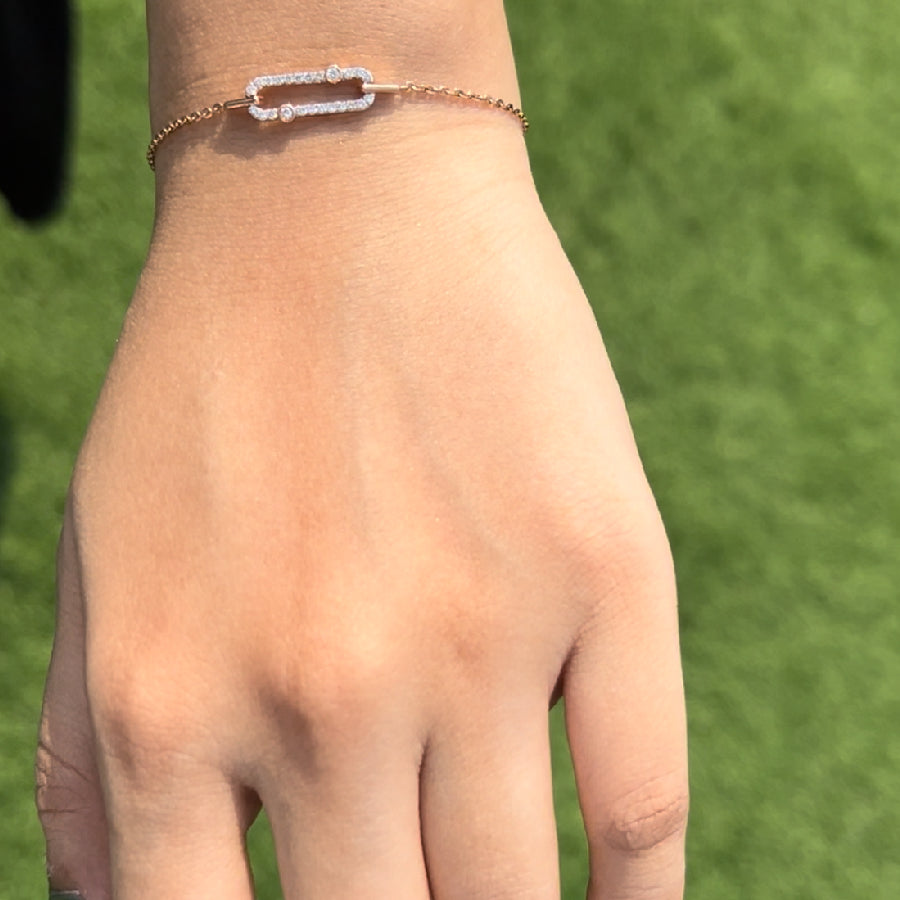 A stylish and elegant bracelet by jnjbymadhuri, showcased on the wrist with a minimalist yet striking rectangular design centerpiece, delicately set in rose gold and accented with shimmering stones—perfect for a graceful and modern look.