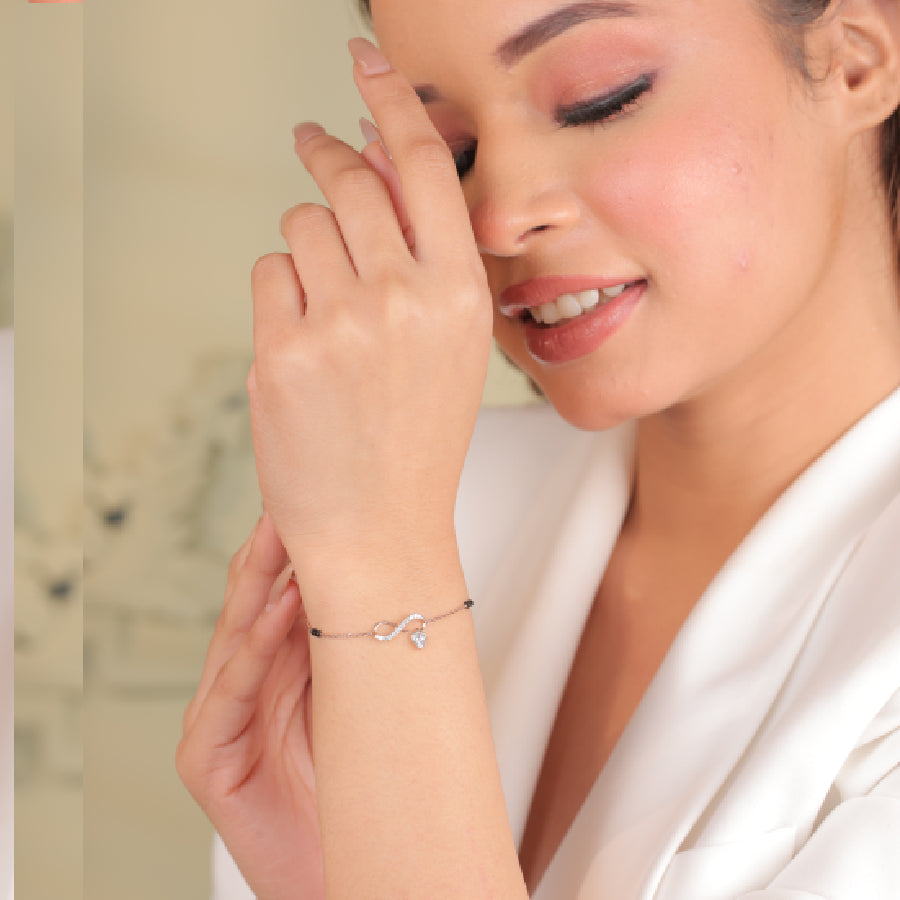 Modern and minimal rose gold infinity mangalsutra bracelet with a delicate heart charm, styled effortlessly for everyday elegance. A refined expression of love by jnjbymadhuri.