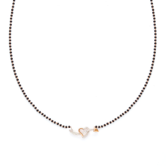 Delicate heart-shaped diamond mangalsutra pendant with classic black beaded chain, symbolizing timeless love. Crafted with elegance and grace by jnjbymadhuri.