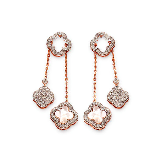 Delicate and graceful, these floral drop earrings showcase a stunning interplay of pearls and shimmering stones—an elegant statement from jnjbymadhuri.