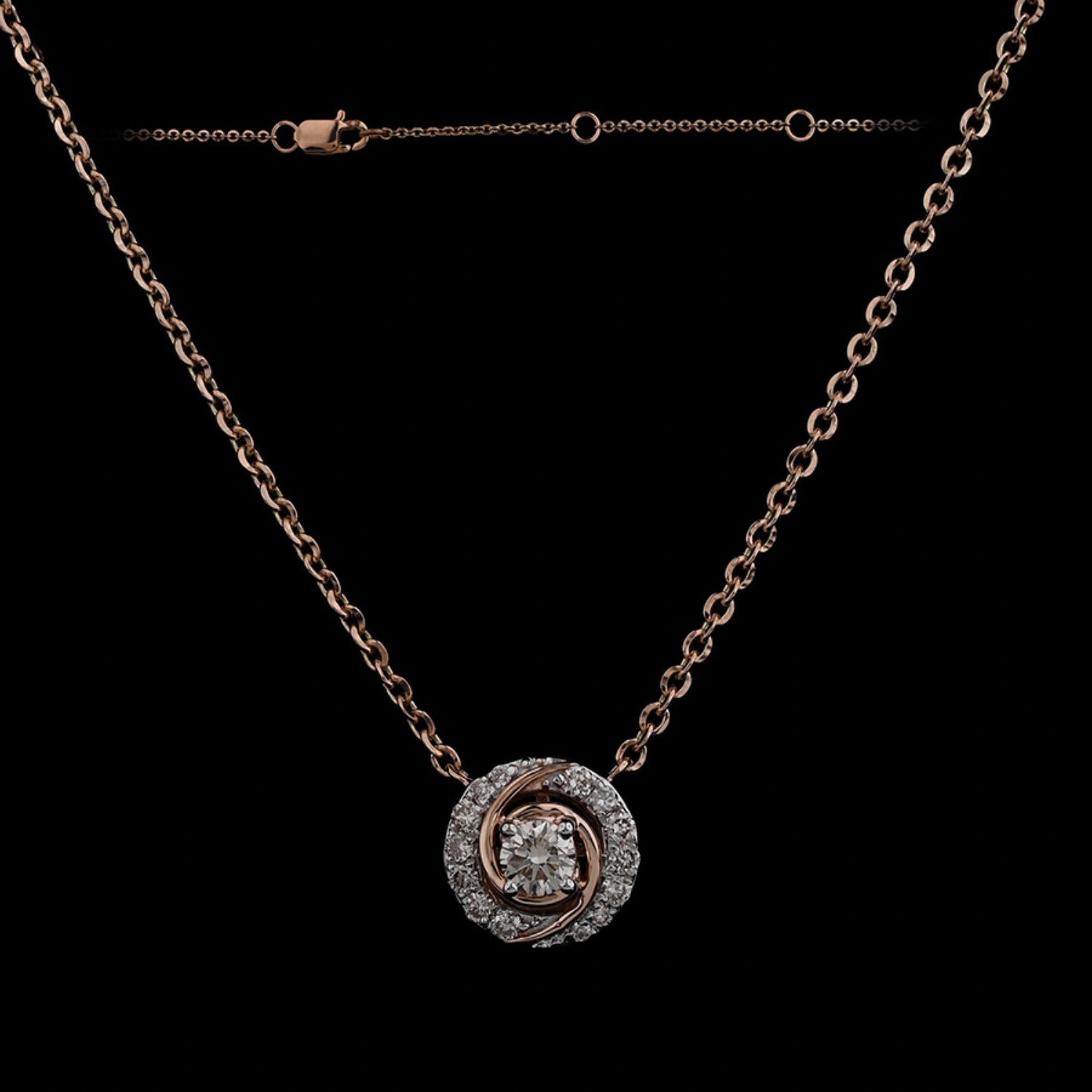 Stylish rose gold and diamond circular pendant necklace by jnjbymadhuri, displayed against a black background highlighting its intricate design and fine craftsmanship.
