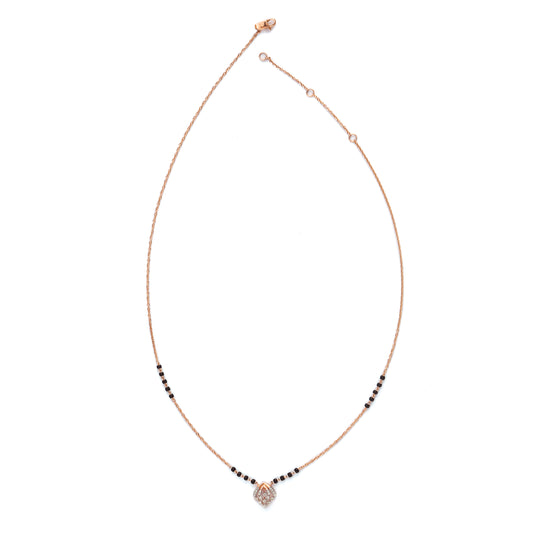 Contemporary mangalsutra with a sleek black and gold beaded chain, featuring a diamond-shaped pendant for a modern twist. Designed with elegance and simplicity by jnjbymadhuri.