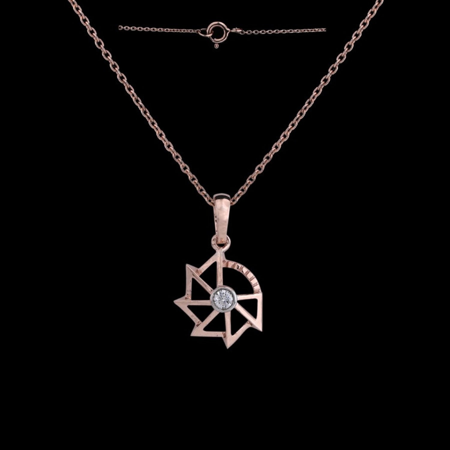 Rose gold pendant necklace by jnjbymadhuri, featuring a modern geometric star design with a central diamond, showcased against a black background with its delicate chain and clasp visible.