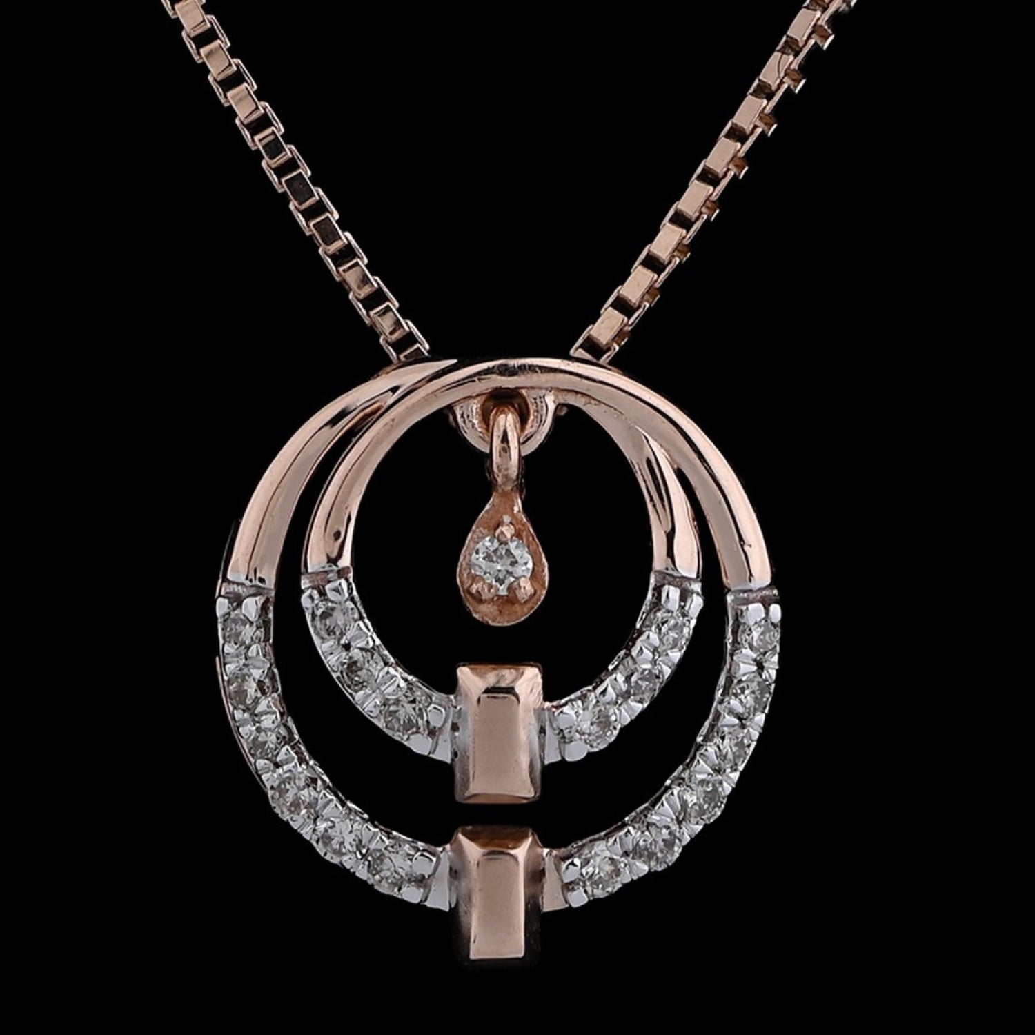 Rose gold and diamond dual-circle pendant necklace by jnjbymadhuri, featuring a teardrop detail and modern geometric elements, displayed on a dark background.