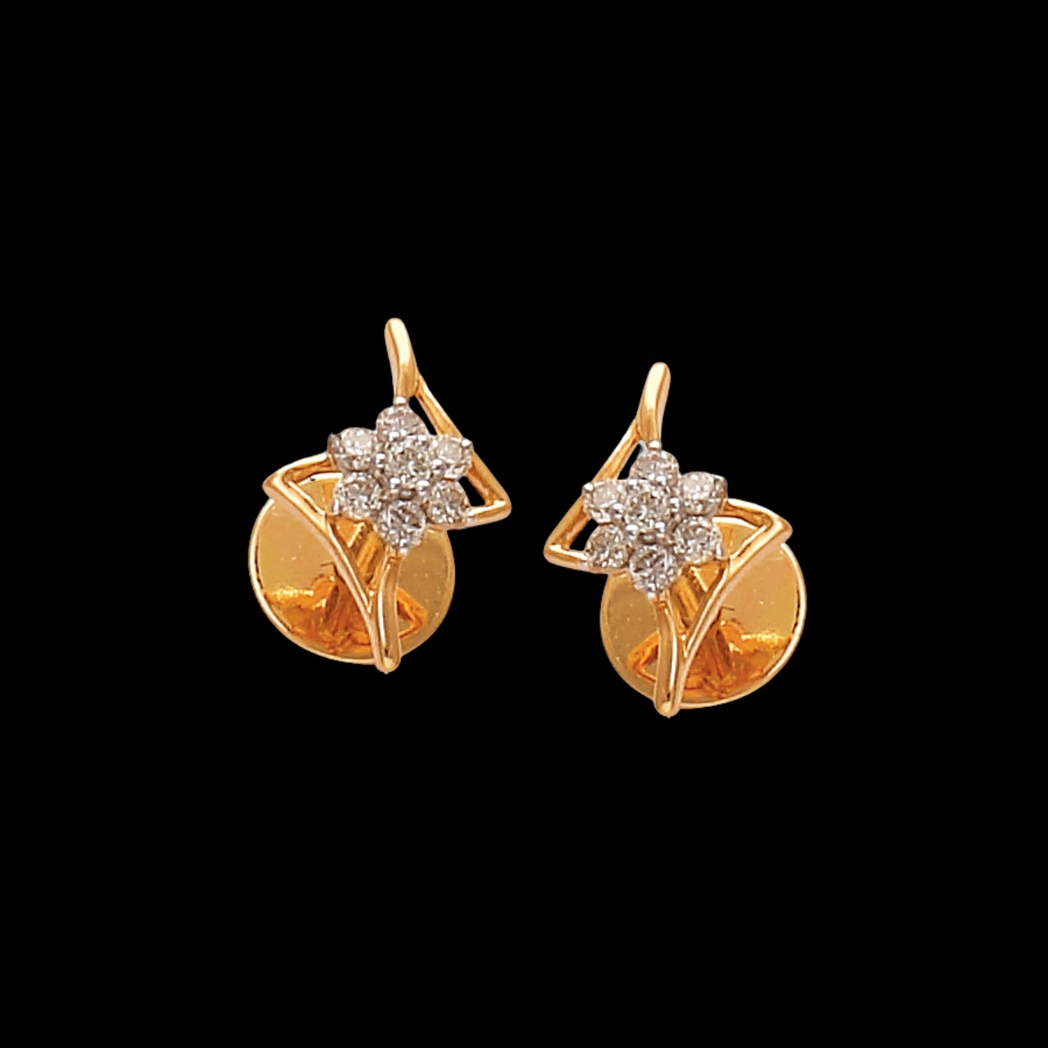 Elegant gold floral earrings by jnjbymaduri, adorned with shimmering diamonds set in a geometric floral pattern, blending tradition with a chic modern twist.