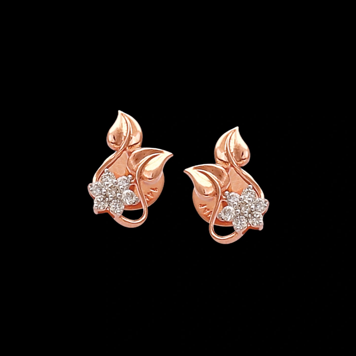 Elegant floral-inspired stud earrings by jnjbymaduri, crafted in rose gold with leaf motifs and sparkling stones, exude a delicate charm perfect for everyday sophistication.