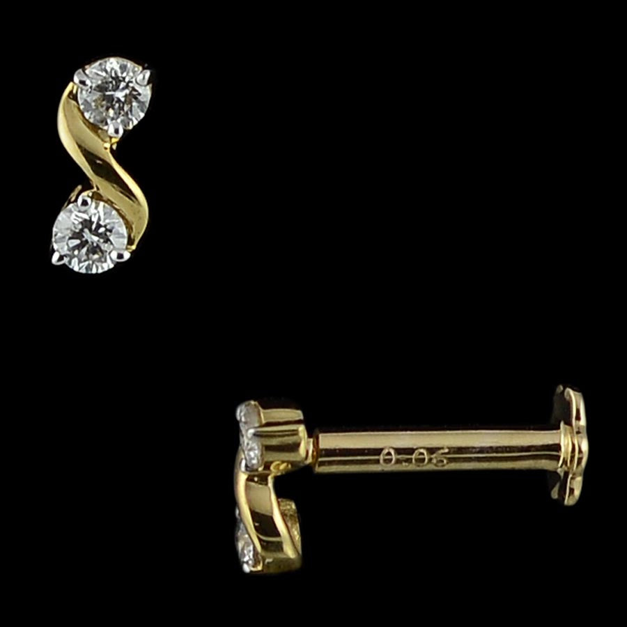Chic gold stud earring showcasing two brilliant diamonds in an elegant S-shaped design. A graceful everyday statement from jnjbymadhuri.