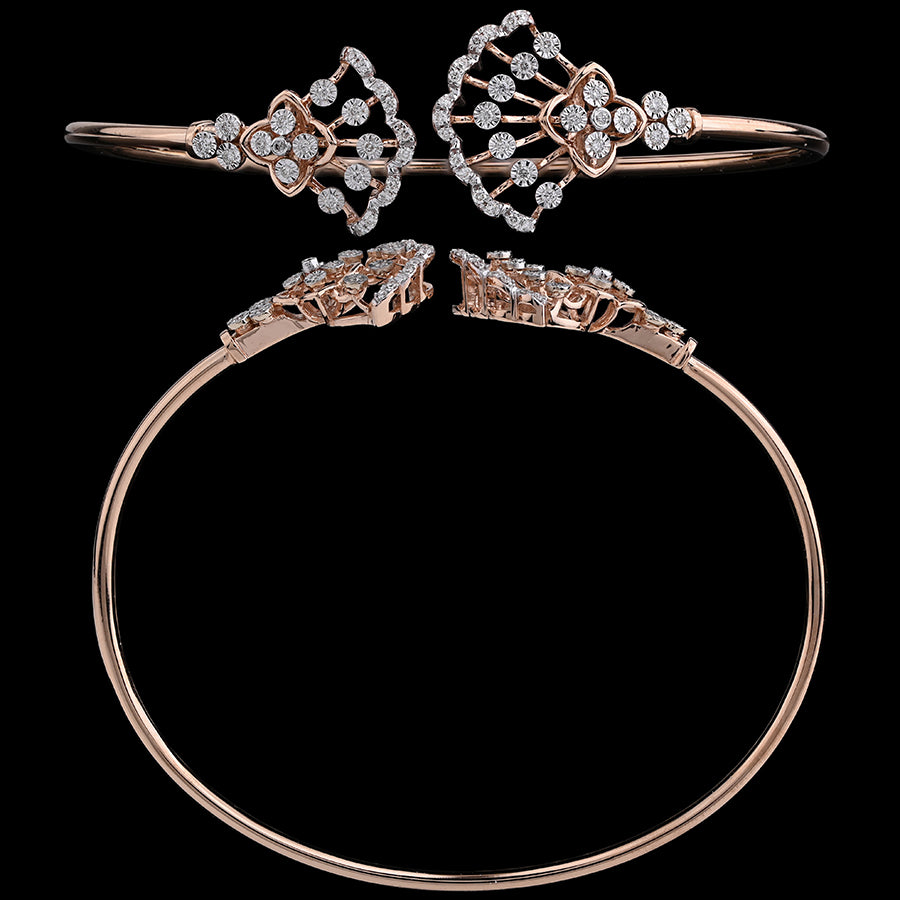 This stunning bracelet by jnjbymadhuri features dual fan-shaped diamond motifs, gracefully arranged in a mirror design. The open-ended rose gold band adds a touch of modern flair to its traditional elegance.
