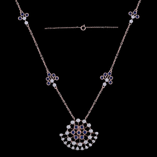 Stunning rose gold necklace with a floral fan-shaped pendant, embellished with black and white stones, and matching motif accents along the chain. A refined and artistic design by jnjbymadhuri.