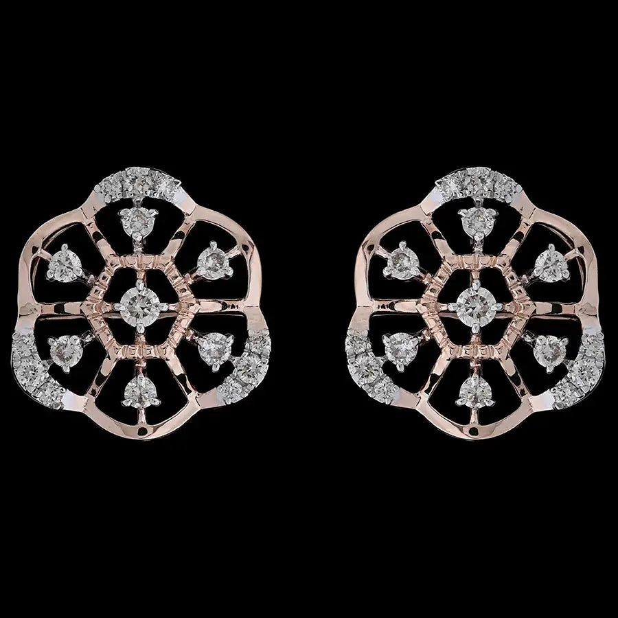 Intricately designed floral motif earrings in rose gold, highlighted with sparkling white stones arranged in a symmetrical pattern. These artistic studs by jnjbymadhuri bring a touch of tradition with contemporary elegance.