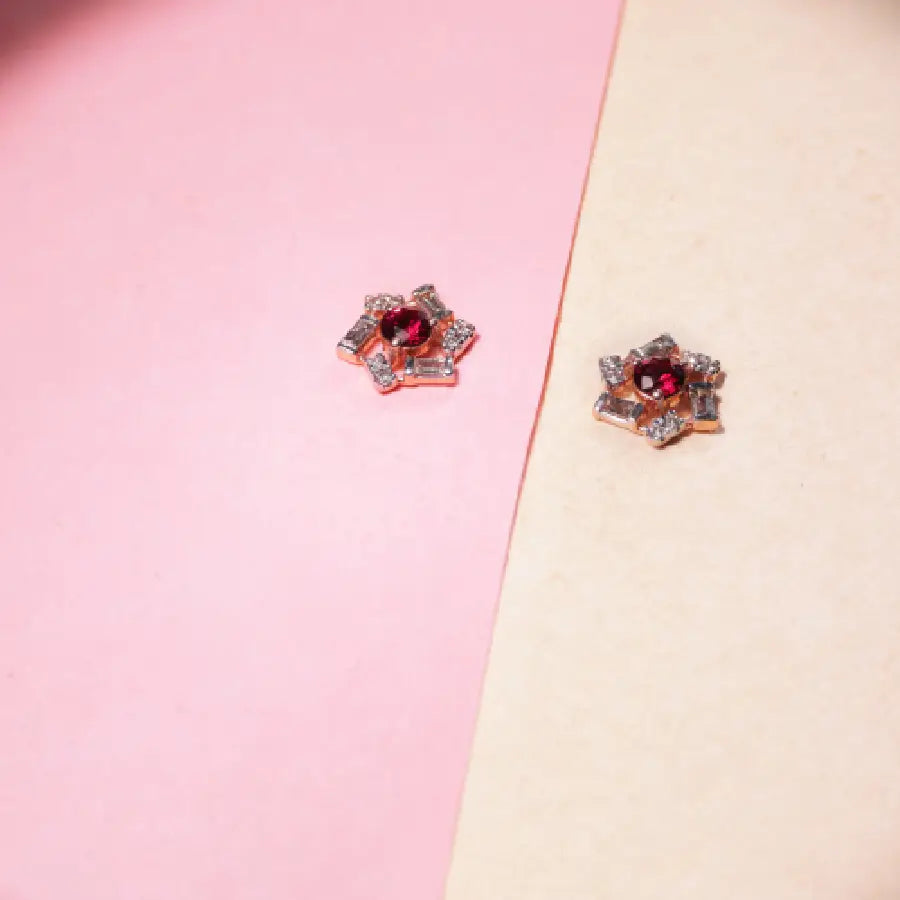 These earrings from jnjbymadhuri combine radiant red stones, dazzling crystals, and a floral-inspired design in rose gold to create a statement of understated luxury. Perfect for elevating your everyday elegance or adding a refined sparkle to festive occasions.