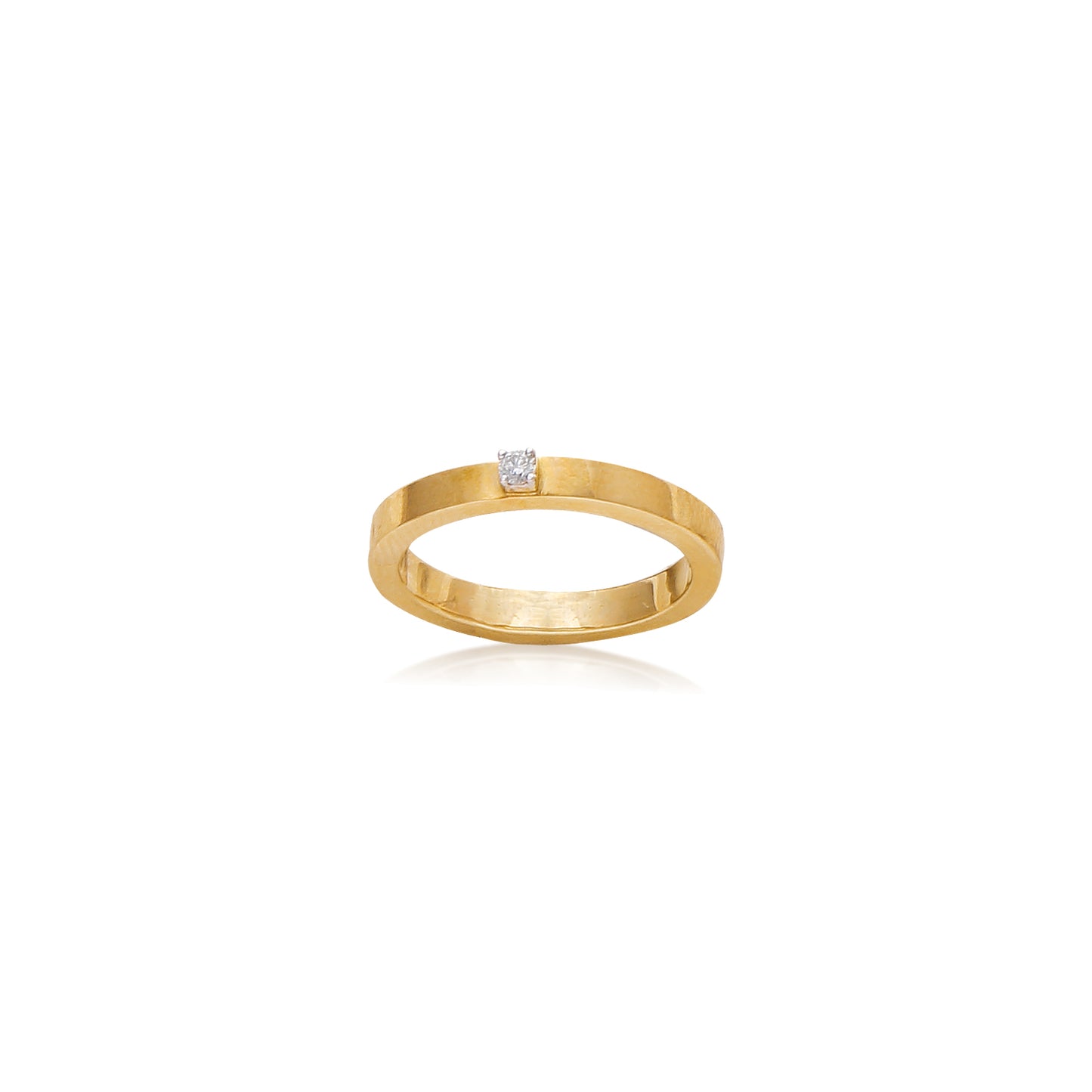 Sleek gold band ring adorned with a single sparkling diamond at the center for a minimal yet luxurious look. A timeless classic by jnjbymadhuri.