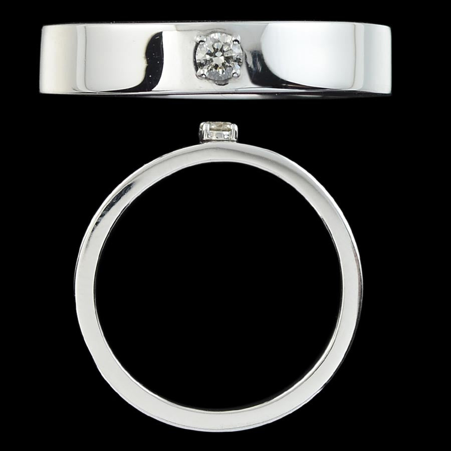 A sleek silver men’s ring with a centrally set diamond, showcasing modern elegance and minimalism. Crafted by jnjbymadhuri, this band embodies timeless sophistication for every special moment.