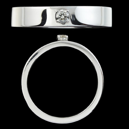 A sleek silver men’s ring with a centrally set diamond, showcasing modern elegance and minimalism. Crafted by jnjbymadhuri, this band embodies timeless sophistication for every special moment.