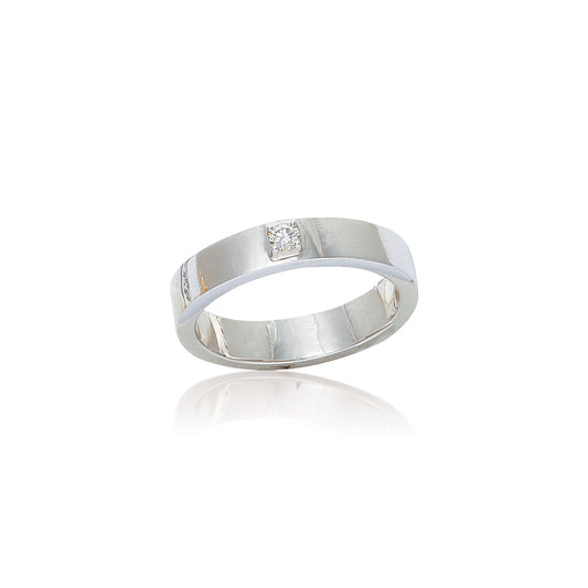 This ring showcases a minimalist and modern design with a wide, polished silver band. At its center, a single diamond or gemstone is subtly set, adding just the right touch of elegance without overpowering the clean lines. It’s a great choice for someone who values simplicity and sophistication, often suited for both everyday wear and formal occasions—also a popular style for men's wedding bands.
