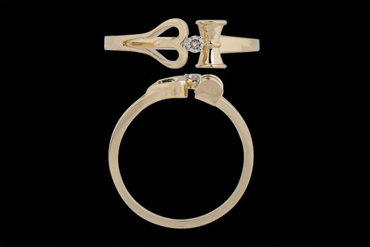 This is another view of the same distinctive gold ring, reinforcing its key design elements: the heart-shaped motif, vertical bar, and central diamond. The top-down and side angles clearly showcase the precision of the cut and symmetry, underlining its elegant yet symbolic appeal—an excellent representation of jnjbymadhuri's craftsmanship.