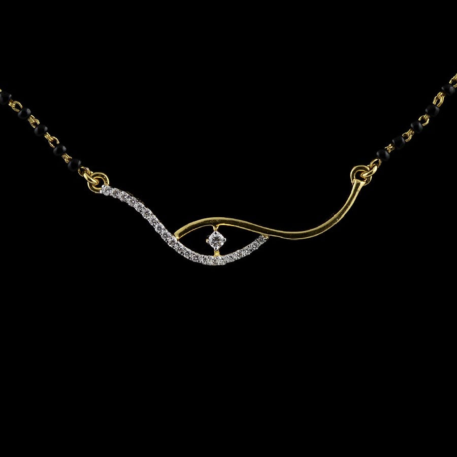 Close-up of a gold and diamond mangalsutra with a modern twisted pendant design, featuring a central diamond framed by a wave-like curve, set against a black background."