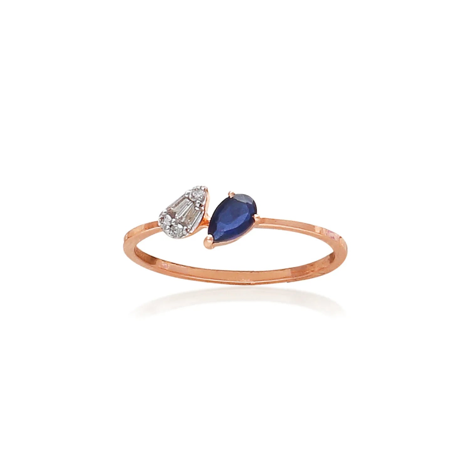Elegant open-top ring from jnjbymadhuri featuring a teardrop-shaped sapphire stone paired with a matching diamond accent on a rose gold band, displayed on a white background.
