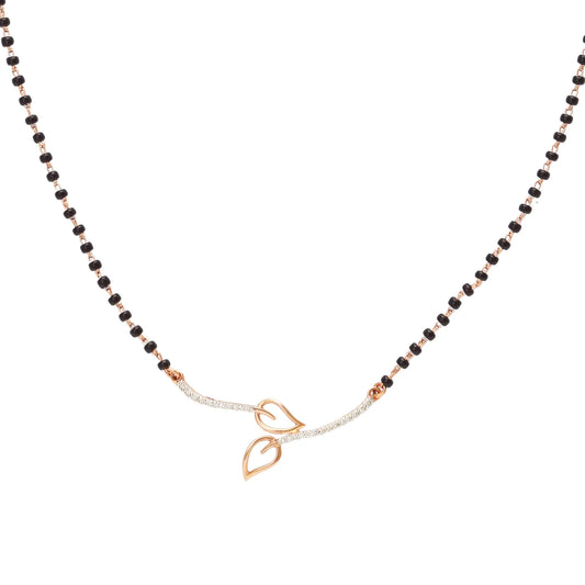 Minimalist mangalsutra by jnjbymadhuri featuring a sleek black beaded chain with a contemporary double-leaf motif in gold at the center, perfectly balancing tradition with modern elegance.