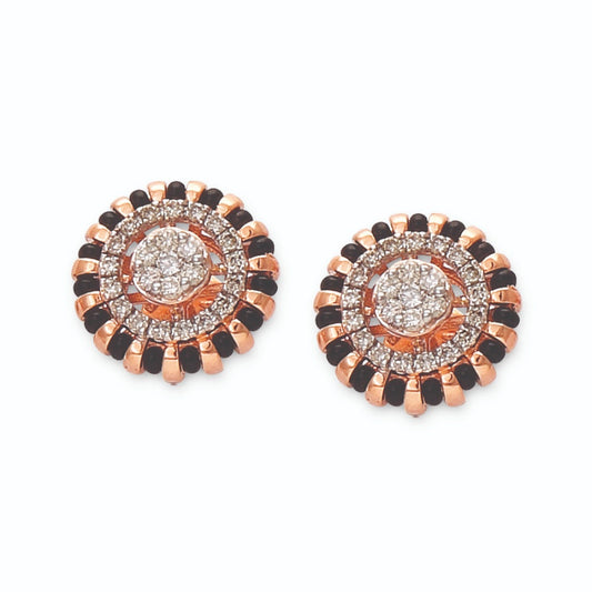 Stunning circular earrings featuring concentric layers of black and white stones with a radiant diamond center. A bold statement design by jnjbymadhuri.
