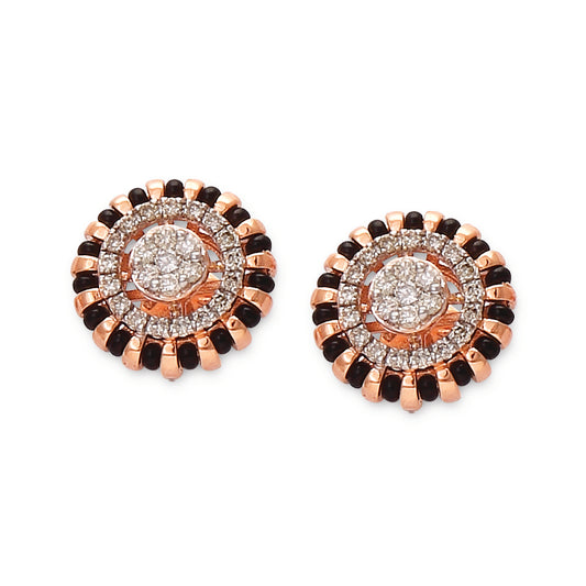 Stunning circular earrings featuring concentric layers of black and white stones with a radiant diamond center. A bold statement design by jnjbymadhuri.
