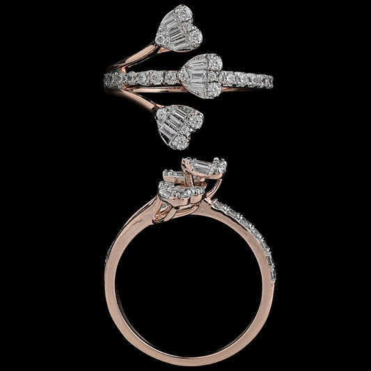 Close-up of a rose gold bypass ring adorned with three sparkling heart-shaped diamond clusters and pavé-set accents. A romantic statement piece by jnjbymadhuri.
