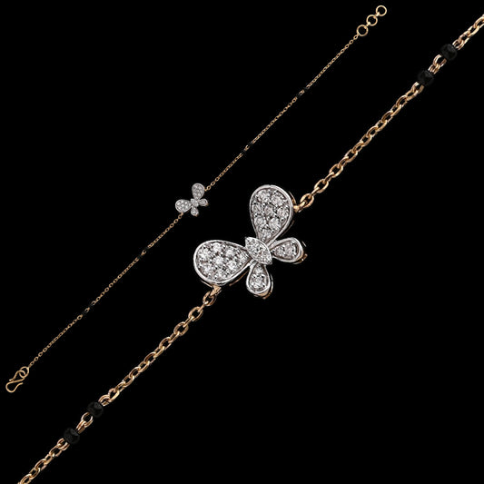 A graceful bracelet by jnjbymadhuri, featuring a diamond-studded butterfly motif on a delicate gold chain. The elegant design blends whimsical charm with timeless sophistication in a refined two-tone finish.