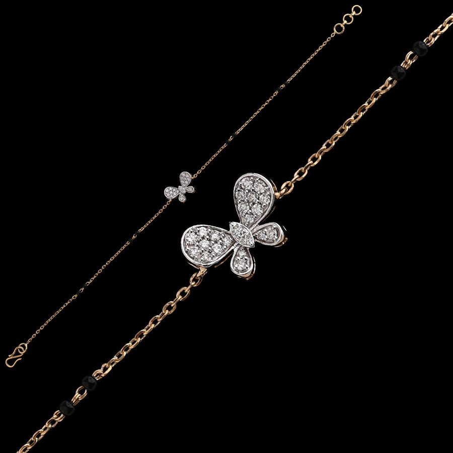 A graceful bracelet by jnjbymadhuri, featuring a diamond-studded butterfly motif on a delicate gold chain. The elegant design blends whimsical charm with timeless sophistication in a refined two-tone finish.
