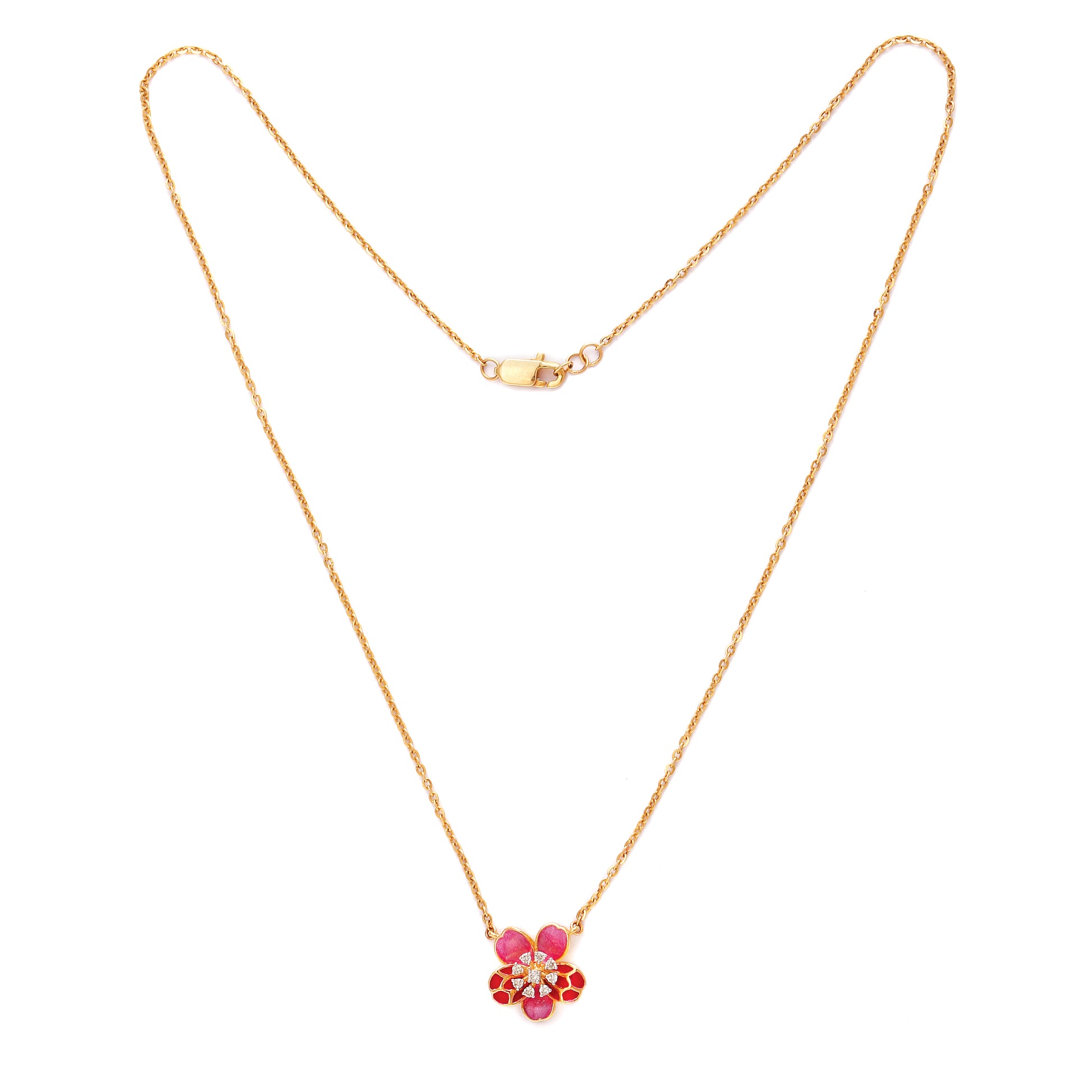 Delicate gold necklace by jnjbymadhuri featuring a floral pendant adorned with red and pink stones, displayed on a white background.
