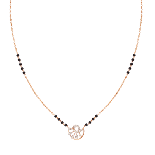 Elegant mangalsutra with a round diamond floral pendant and classic black beads on a gold chain. A timeless piece from jnjbymadhuri combining tradition with grace.
