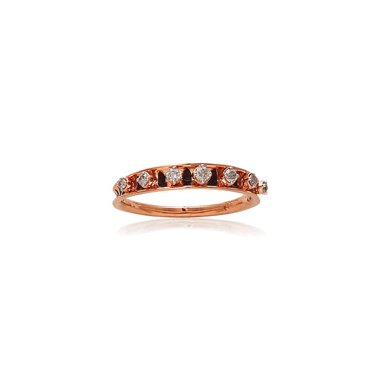 Rose gold eternity band by jnjbymadhuri featuring a row of round-cut diamonds set in a delicate channel setting, displayed on a white background with a subtle reflection beneath.
