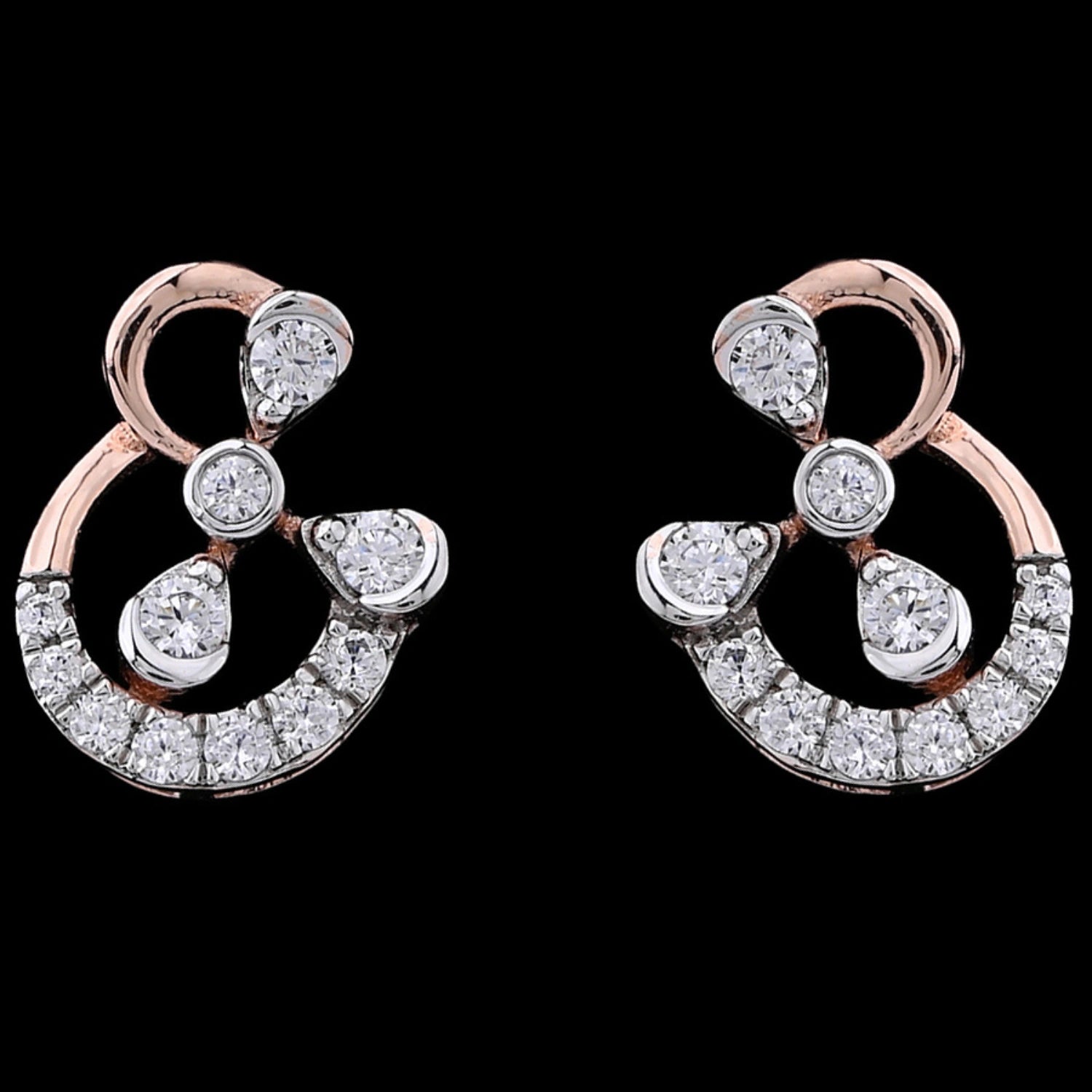 "Elegant rose gold earrings from jnjbymadhuri featuring an abstract ampersand-inspired design, adorned with sparkling round and teardrop-shaped diamonds, showcased on a black background."
