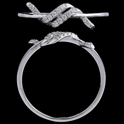 Close-up view of a white gold diamond ring featuring an intricate intertwined design, by jnjbymadhuri, displayed against a black background.
