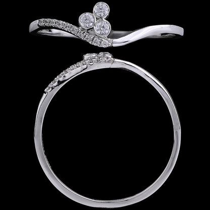 A sleek silver ring featuring a delicate wavy band and three sparkling diamonds arranged in a floral motif, showcased against a black background to highlight its refined craftsmanship and elegance, from jnjbymadhuri.
