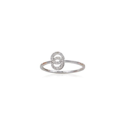 A delicate and contemporary silver ring featuring an open circular motif encrusted with sparkling stones, displayed against a clean white background to emphasize its elegance and minimalist charm by jnjbymadhuri.
