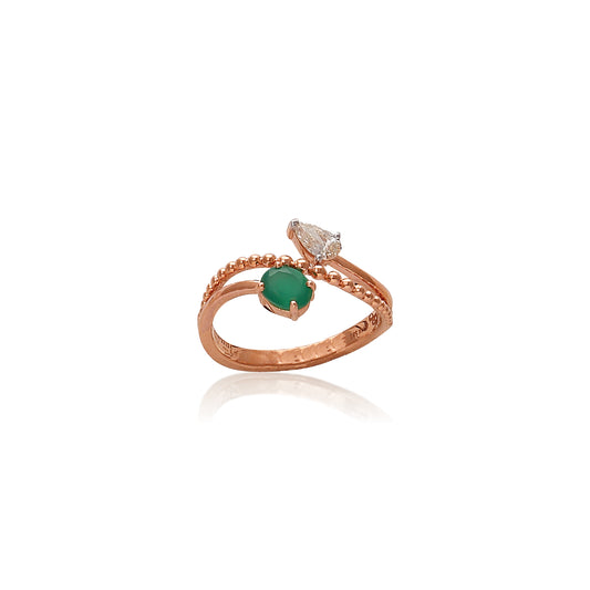 Rose gold ring with an elegant twist design featuring a green gemstone and pear-shaped diamond accent, beautifully crafted by jnjbymadhuri.
