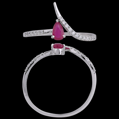 Elegant ruby teardrop ring set in a sleek silver band with delicate diamonds, showcasing refined grace by jnjbymadhuri.
